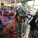 Jared Bentley, left, dressed as My Little Pony cartoon character, The Smooze, helps his friend Daniel Chadborn dressed as a samari Dischord (AP Photo/Mel Evans)