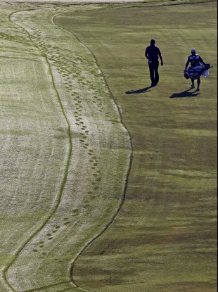 Steven Bowditch and his caddie walk along the 10th fairway.