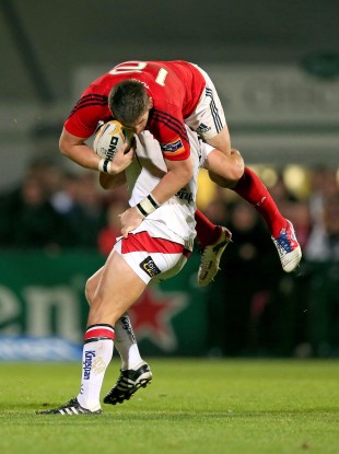 Michael Allen of Ulster takes Munster's James Downey for a ride.