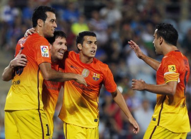FC Barcelona's Lionel Messi from Argentina, second left, celebrates his goal with team mates during a Spanish La Liga soccer match against Getafe at the Coliseum Alfonso Perez stadium in Getafe.