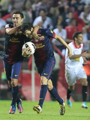 Barcelona's Cesc Fabregas, right, reacts after scoring with Xavier Hernandez, left, against Sevilla during their La Liga soccer match at the Ramon Sanchez Pizjuan stadium.