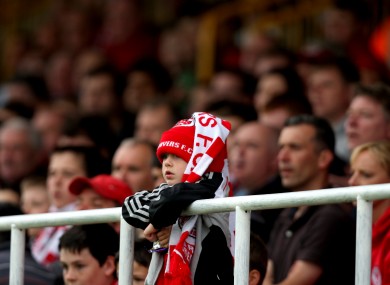 A young Sligo Rovers fan watches his team.
