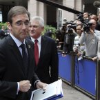 A bashful looking Pedro Passos Coelho, Portugal's Prime Minister, will certainly not be getting any smooches from Angela. (AP Photo/Yves Logghe)