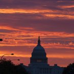 In Washington, the US Capitol dome is silhouetted as the sun rises. (AP Photo/J. Scott Applewhite)