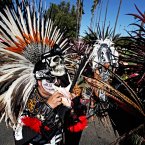 Visitors wearing traditional costumes take part in a procession marking Dia de los Muertos (Day of the Dead) at the Hollywood Forever Cemetery in the Hollywood section of Los Angeles on Saturday. (AP Photo/Richard Vogel)