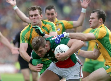 Neil and Eamon McGee combine to tackle Mayo's Aidan O'Shea.