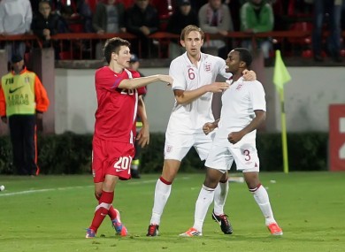 Serbian player Milos Ninkovic, left, and England's Danny Rose, right, and Craig Dawson, centre, clash during their 2013 European Under-21 Championship play-off.