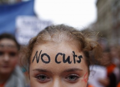 A teacher protesting against cuts during the week