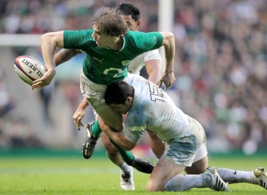 Andrew Trimble offloads in the tackle against England.