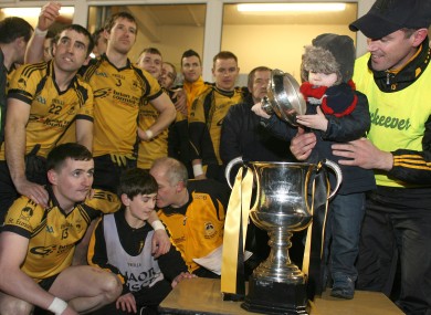 Brendan Devenny and his son Matthew inspect the cup before it is presented to St Eunan's captain Michael Martin.