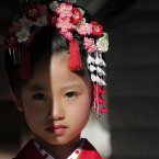 A girl wearing kimono poses for her father at a festival to celebrate children's growth and pray for their future well-being, at Meiji Jingu in Tokyo, Sunday, Nov. 18, 2012. (AP Photo/Itsuo Inouye)
