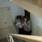 Israeli women take cover in a stairwell as a siren signals the warning of incoming rockets in the coastal city of Ashkelon.
(AP Photo/Tsafrir Abayov)