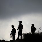 Israeli border policemen stand guard during a protest against Israel's military action on the Gaza Strip in Birzeit.
(AP Photo/Nasser Shiyoukhi)