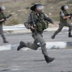 Israeli border policemen run during a protest against the Israeli military operations in Gaza Strip near the West Bank city of Nablus.
(AP Photo/Nasser Ishtayeh)