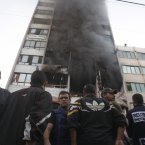 People stand in front of a high rise housing media organizations in Gaza City, Monday.
(AP Photo/Hatem Moussa)