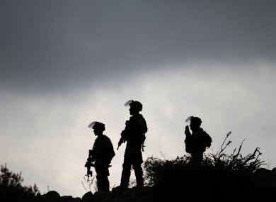 Israeli border policemen stand guard during a protest against Israel's military action on the Gaza Strip in Birzeit