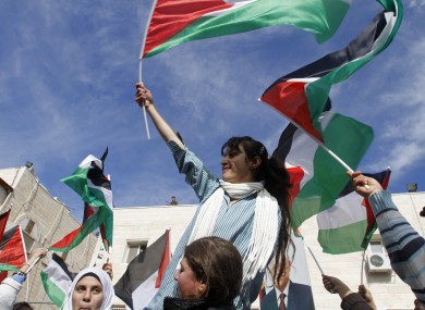 Palestinian schoolgirls wave Palestinian flags during a rally supporting the Palestinian UN bid for observer state status, in the West Bank city of Ramallah today