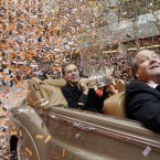 San Francisco Giants manager Bruce Bochy holds the World Series trophy as confetti falls during the baseball team's World Series victory parade, in San Francisco. (AP Photo/Jeff Chiu)