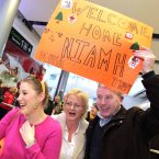 Niamh Bohan (23) from Cork City is a little embarrassed by her parents Noel and Yvonne after traveling home from Singapore for Christmas today at Dublin Airport. Photo: Mark Stedman/Photocall Ireland