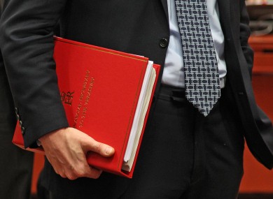 British Financial Secretary to the Treasury Greg Clark, holds his documents, during the EU finance ministers meeting, at the European Council building in Brussels