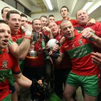 Celebration time. Ballymun Kickhams manager Paul Curran (centre) with his players after they claim their first ever provincial senior crown. (INPHO/James Crombie).