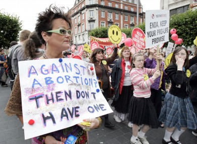 Pro-choice supporter Rhonda Donaghey holds a pro-choice placard as she watches a pro-life demonstration in July 2011.