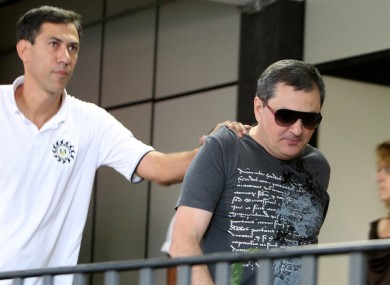 Mauro Hoffmann, right, co-owner of the Kiss nightclub, is escorted by police as he voluntarily surrenders at a police station in Santa Maria, Brazil.