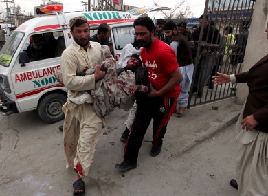 Pakistani volunteers rush an injured victim from a bomb blast in a commercial area to a local hospital in Quetta, Pakistan, Thursday, Jan. 10, 2013