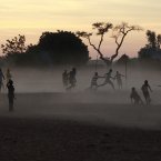 Children and adults alike play soccer on a dusty field in Segou, central Mali, some 240 km from Bamako. French troops in armoured personnel carriers rolled through the streets of Diabaly on Monday, winning praise from residents of this besieged town after Malian forces retook control of it with French help a week after radical Islamists invaded. The Islamists also have deserted the town of Douentza, which they had held since September, according to a local official who said French and Malian forces arrived there on Monday as well. (AP Photo/Jerome Delay)