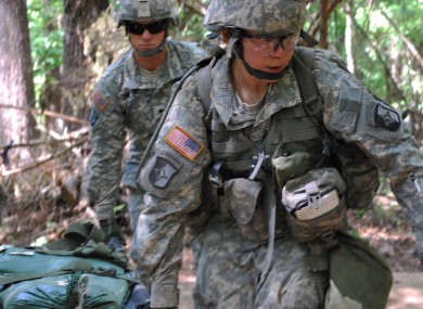 In a 9 May, 2012 file photo, Captain Sara Rodriguez, 26, of the 101st Airborne Division, carries a litter of sandbags during the Expert Field Medical Badge training at Fort Campbell, Kentucky.