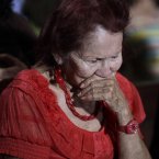 A woman reacts as people gather to pray for Venezuela's President Hugo Chavez at a church in Caracas, Venezuela. (AP Photo/Ariana Cubillos)