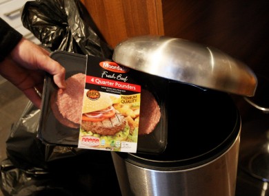A packet of burgers is thrown into a bin.
