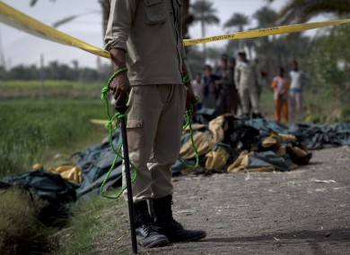 An Egyptian policeman stands guard at the side of the balloon accident