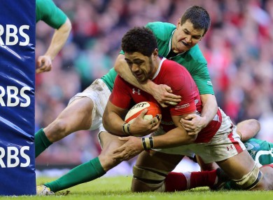 Jonathan Sexton just prevents Toby Faletau scoring for Wales.