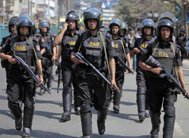Bangladeshi security personnel patrol in front of Baitul Mukarram mosque in Dhaka, Bangladesh.