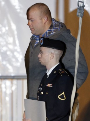 Army Pfc. Bradley Manning, front, is escorted out of a courthouse in Fort Meade yesterday.