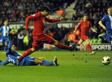 Liverpool's Luis Suarez scores his hat-trick and the fourth goal of the game for his side against Wigan.