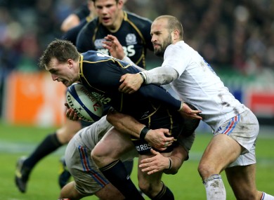 Stuart Hogg is grabbed by Freddy Michalak.